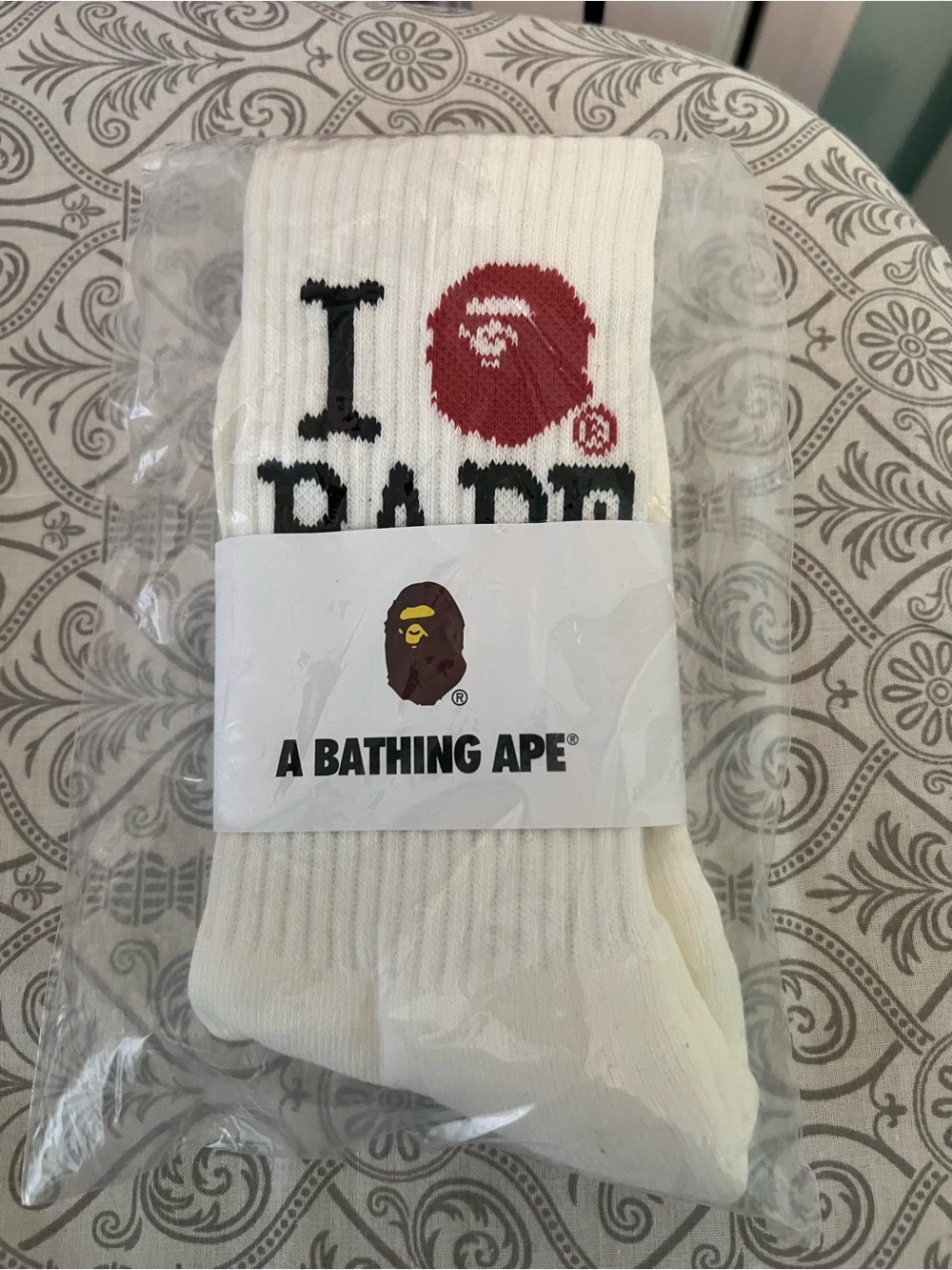 Bape White Crew Socks with Red Ape Logo and Black Text